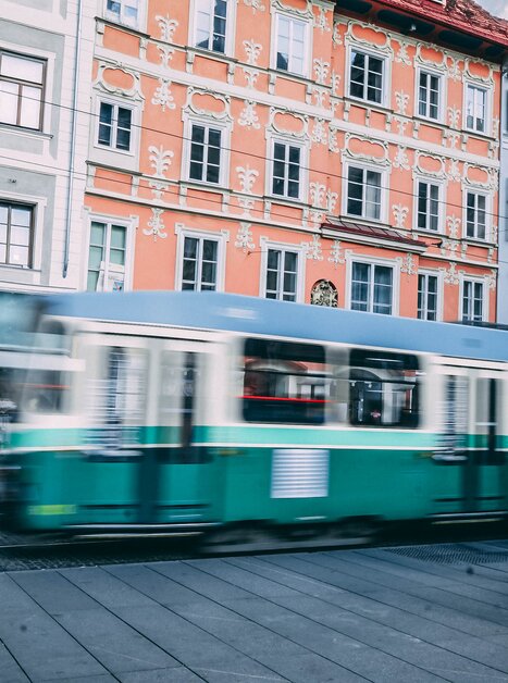 A green tram passes by as pedestrians stand outside the Palmers store. | © Janet Newenham - Journalist On The Run