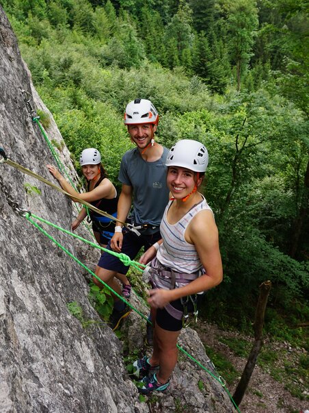 Three climbers on a rock wall in the forest, enjoying their climbing. | © Focus Climbing Graz