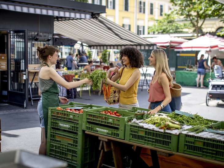 Two women buying fresh vegetables at the Kaiser Josef market. | © Graz Tourismus - Tom Lamm