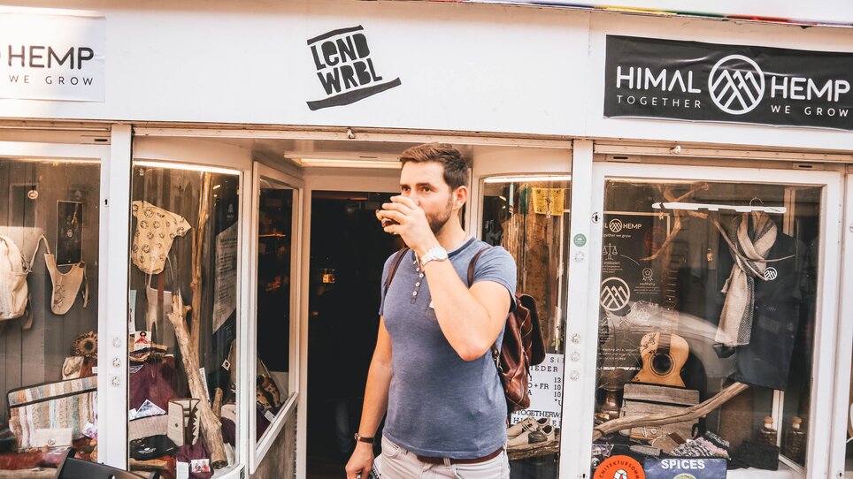 Ein Mann genießt ein Getränk vor einem Geschäft in Graz. | © Janet Newenham - Journalist On The Run