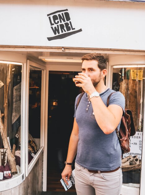 A man enjoys a drink outside a shop in Graz. | © Janet Newenham - Journalist On The Run