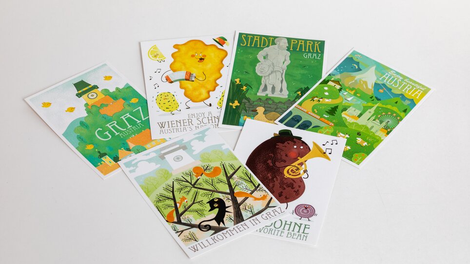 Cartoline con motivi di Graz, tra cui il parco cittadino e la torre dell'orologio. | © Graz Tourismus - Harry Schiffer