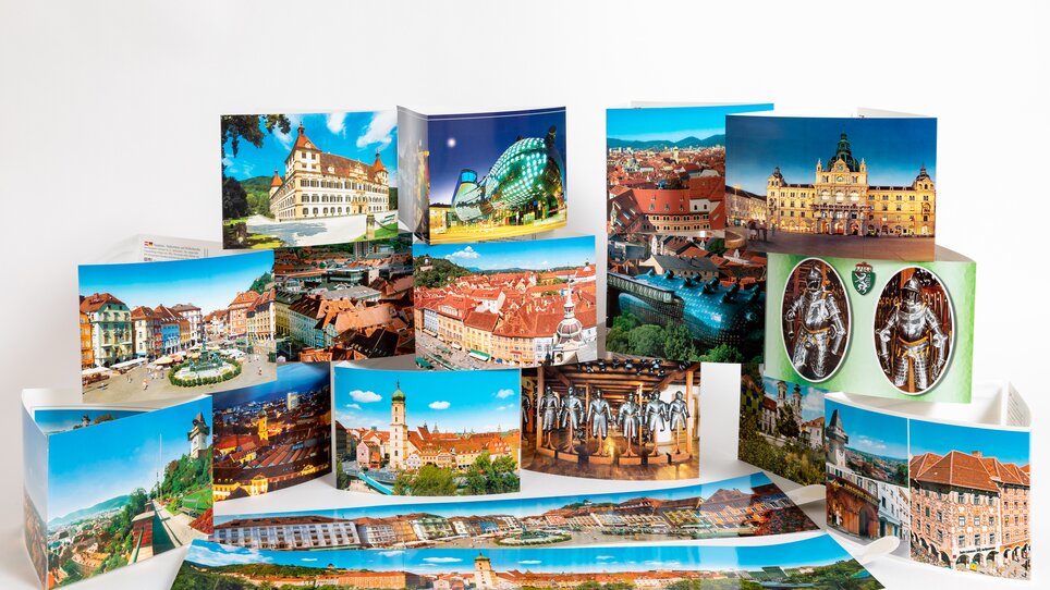 Vista di cartoline di Graz con Murinsel e Torre dell'Orologio. | © Graz Tourismus - Harry Schiffer