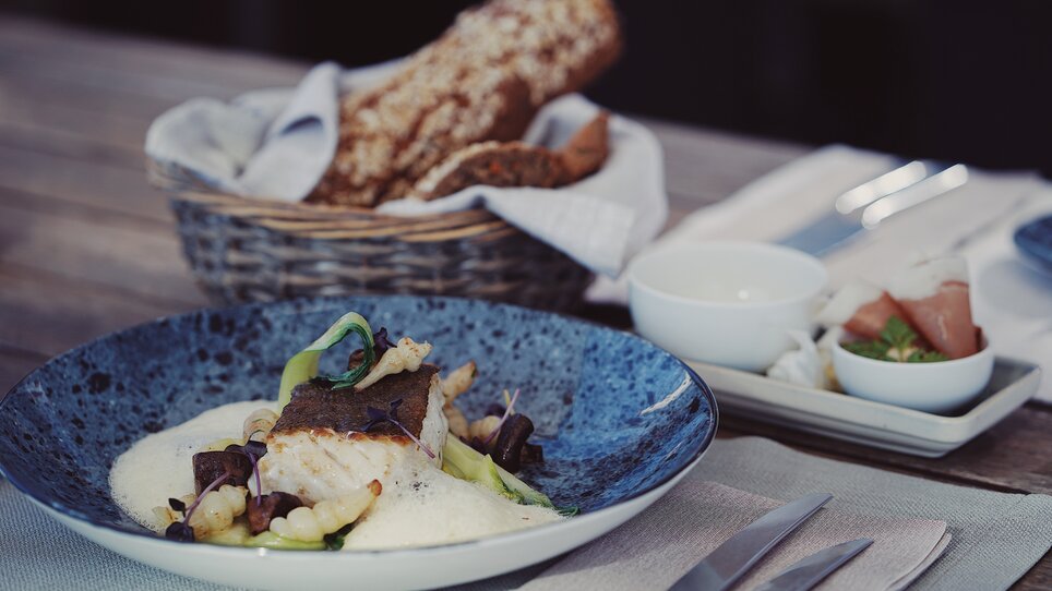 An artistically arranged fish dish with sides. | © aiola