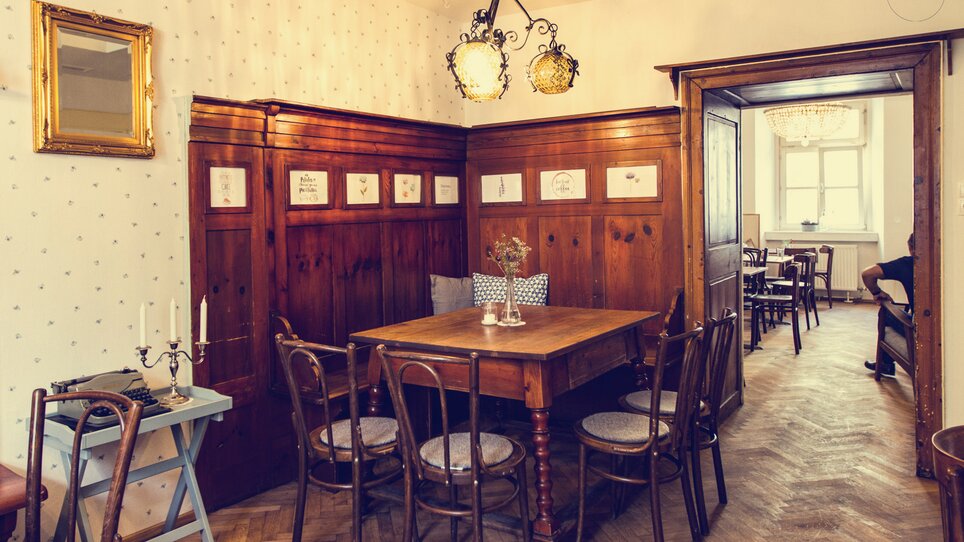 Cozy dining area with wooden chairs and table in the café. | © Cafe Fotter