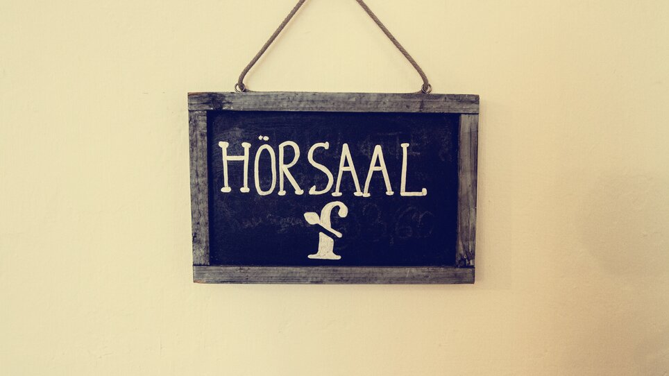 A sign displaying 'HÖRSAAL' with a stylized drawing. | © Cafe Fotter
