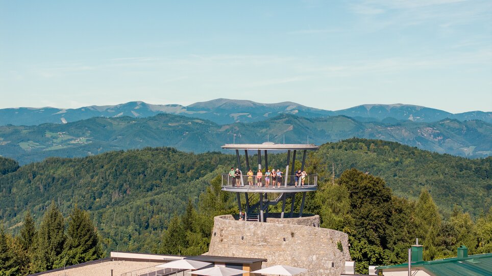 An observation tower with a restaurant in Graz and mountain scenery. | © Graz Tourismus - Mias Photoart