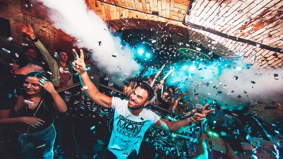 DJ Performance im Kottulinsky Club mit Feiernden und Konfetti.