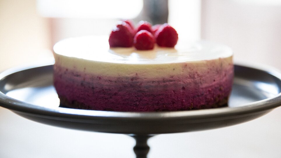 Leckere Erdbeer-Topfen-Torte mit frischen Himbeeren auf einem Etagere. | © Svetlana Gombats Photography 