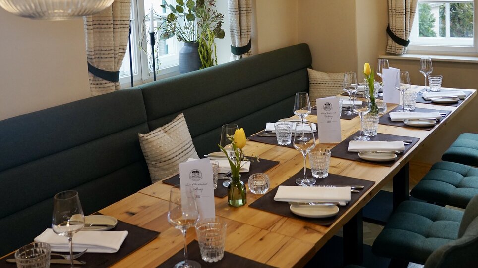 Cozy dining area with elegant table setting and lighting. | © Wirtshaus Schanzlwirt