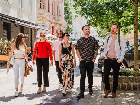 Six people enjoying a sunny day in Graz while strolling. | © 5komma5sinne - MotionAds