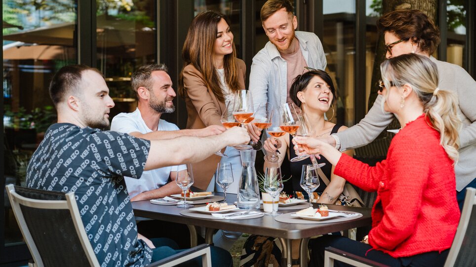 Gruppe von Freunden genießt Drinks und Snacks im Restaurant Florian im Parkhotel Graz. | © 5komma5sinne - MotionAds