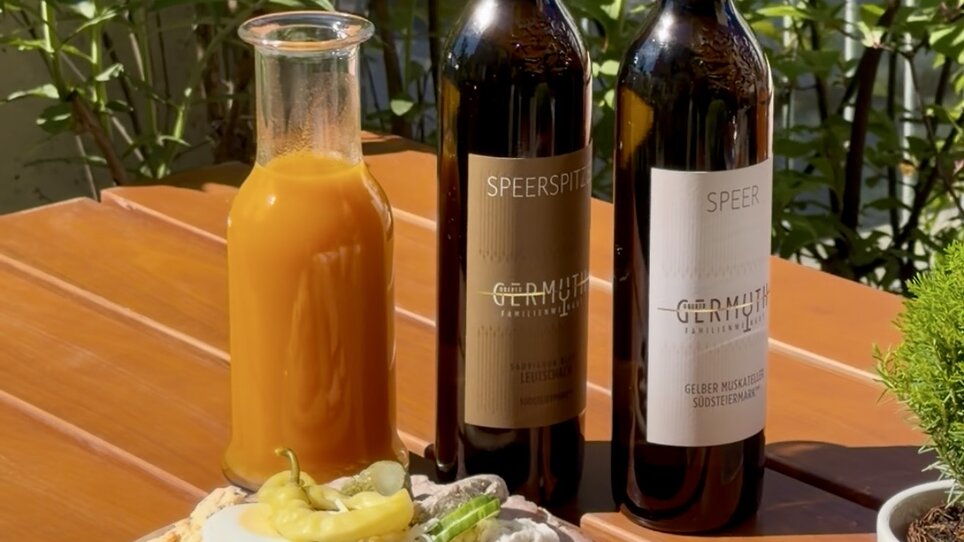 White wine, red wine, and a platter with cheese and ham. | © Schanzlwirt