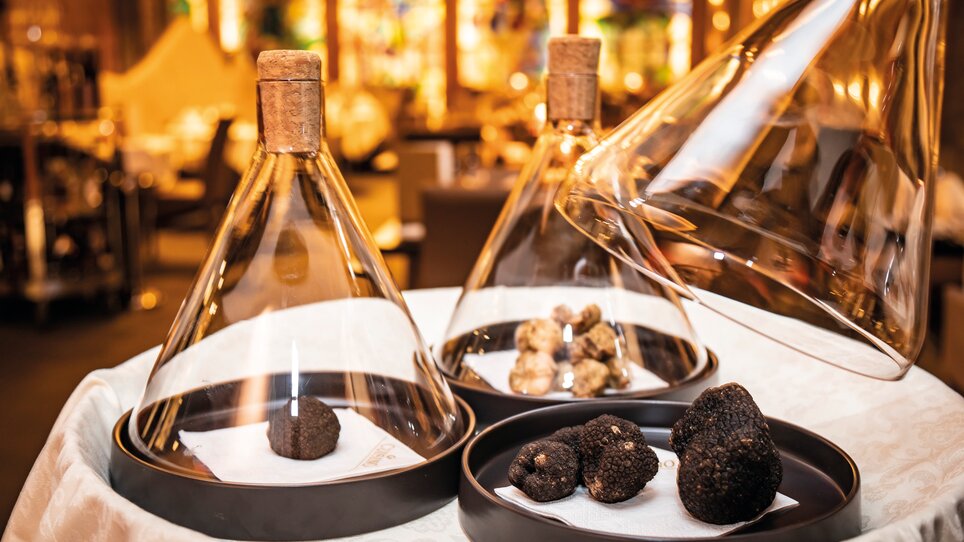 Three glass domes showcasing fine truffles of various kinds on a table. | © Graz Tourismus - Werner Krug