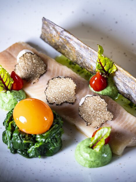 Ein delikates Trüffelgericht mit Fischfilet, Spinat, Eigelb und Trüffelscheiben. | © Graz Tourismus - Werner Krug