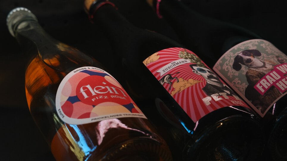 Drei Flaschen mit verschiedenen Schaumweinen in einem Regal. | © Julia Riedesser - 1000things