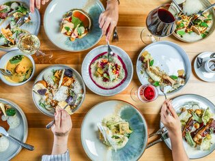 Luxurious dishes and drinks in an elegant restaurant setting. | © Paul Stajan (1)