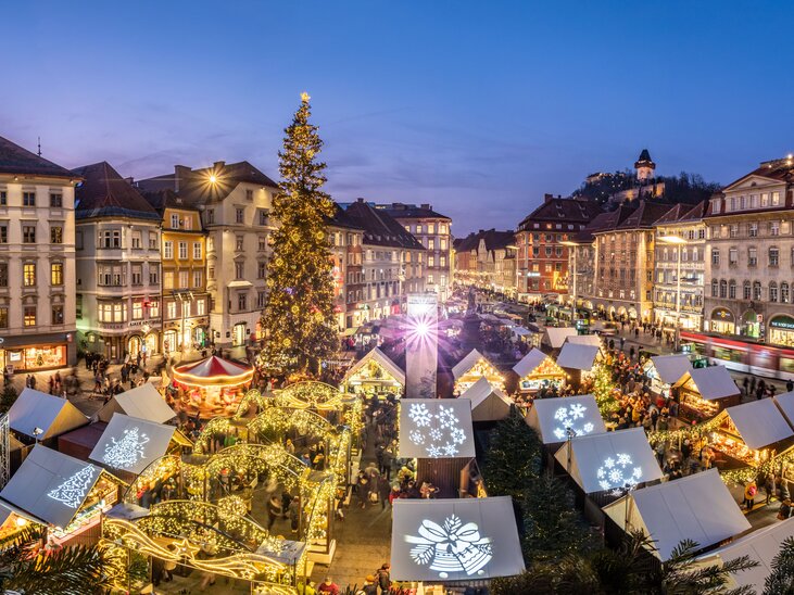 Weihnachtsmarkt in Graz mit festlich beleuchteten Ständen und großer Tanne. | © Graz Tourismus - Rene Walter 
