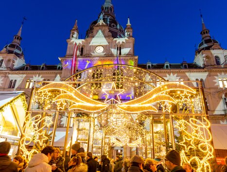 Illuminated Christmas market at Graz Hauptplatz with the city hall in the background. | © Graz Tourismus - Harry Schiffer