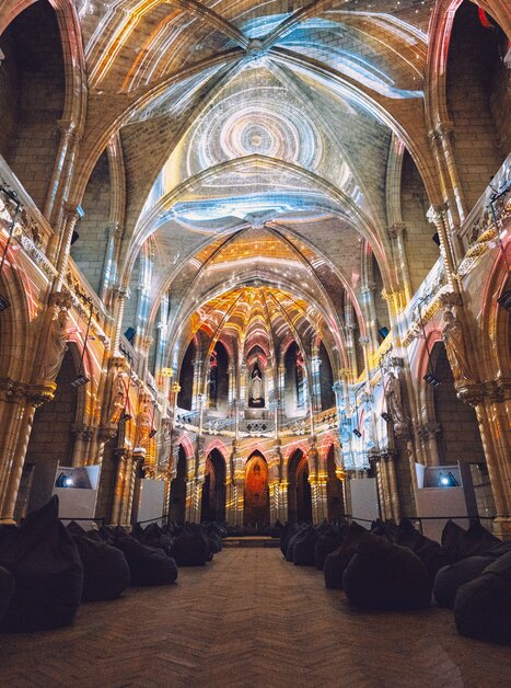 Blick ins Innere einer alten Kirche mit Lichtprojektionen. | © Projektil