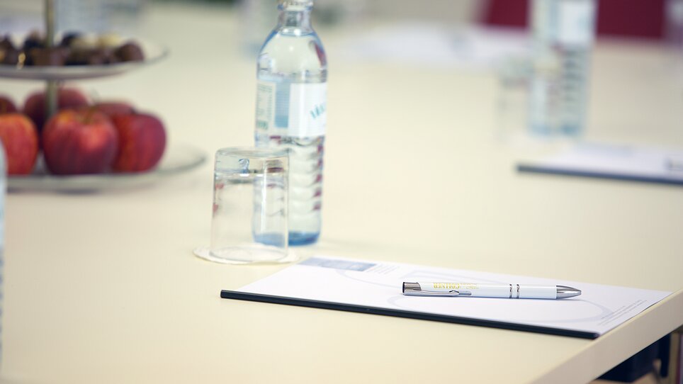 Conference room at the Hotel Gollner with water bottles, apples, and a pen on the table. | © Hotel Gollner