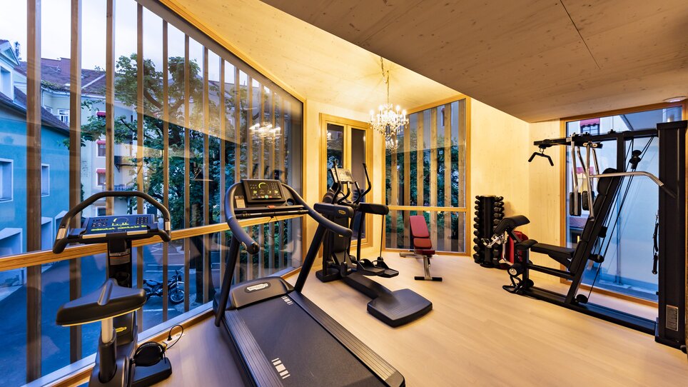 A fitness room in Parkhotel Graz featuring various equipment and an outdoor view. | © Parkhotel Graz
