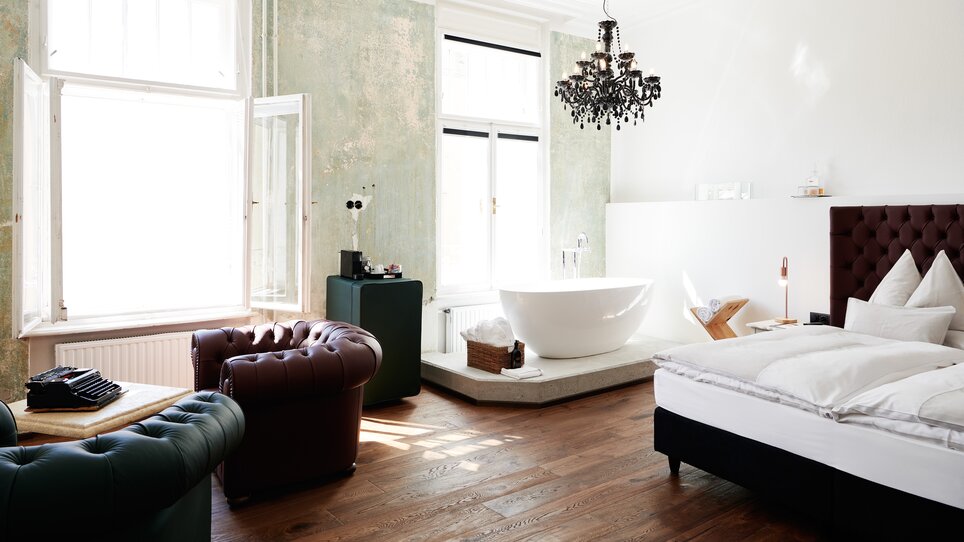 Helles Zimmer mit Badewanne und Chandelier im Grand Hôtel Wiesler. | © Florian Weitzer Hotels & Restaurants