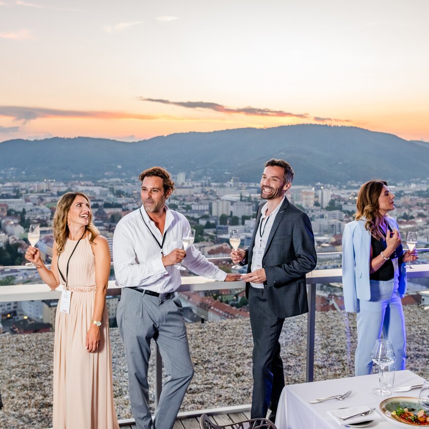 Business team enjoying cocktails with a view of Graz. | © Graz Tourismus - Mias Photoart