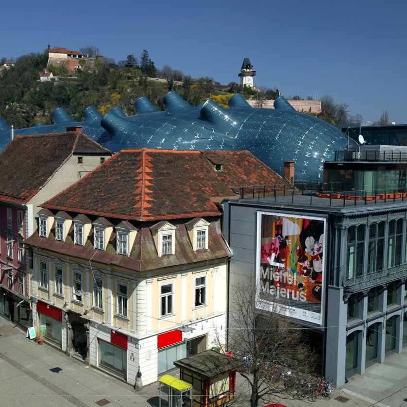 Kunsthaus Graz with Graz Clock Tower | © Graz Tourismus - Harry Schiffer View of Kunsthaus Graz and the Graz Clock Tower. | © Graz Tourismus - Harry Schiffer