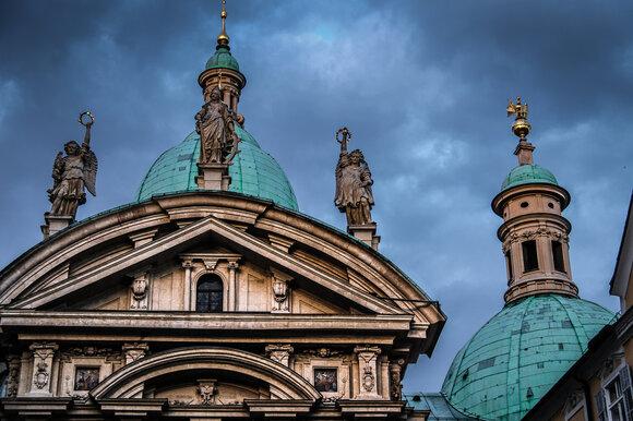 The mausoleum next to Graz Cathedral featuring a shiny dome and statues.