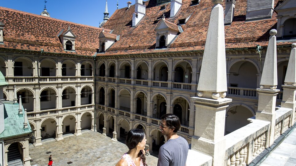 Paar genießt die Aussicht auf den Innenhof im Grazer Landhaushof. | © Graz Tourismus - Tom Lamm