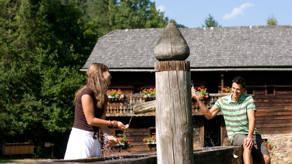 Two people at Open-Air Museum Stübing playing with water. | © Region Graz - Hans Wiesenhofer
