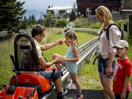 Familie bereitet sich auf eine Sommerrodelbahnfahrt vor | © Region Graz - Tom Lamm
