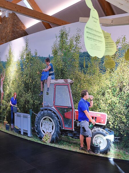 Installation at Gölles vinegar producer with workers and a tractor. | © Gölles