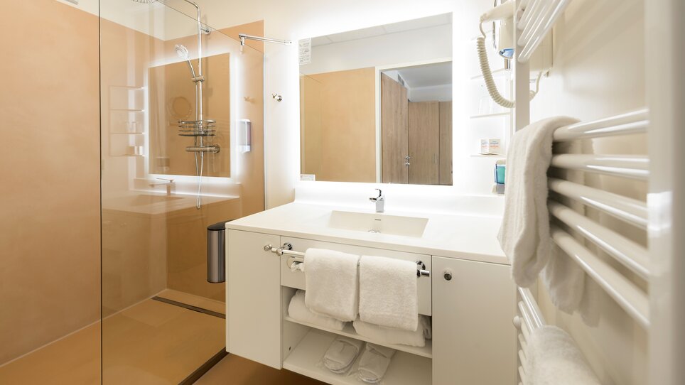 Bagno con doccia e lavandino nel NOVAPARK Hotel. | © Ulrike Rauch