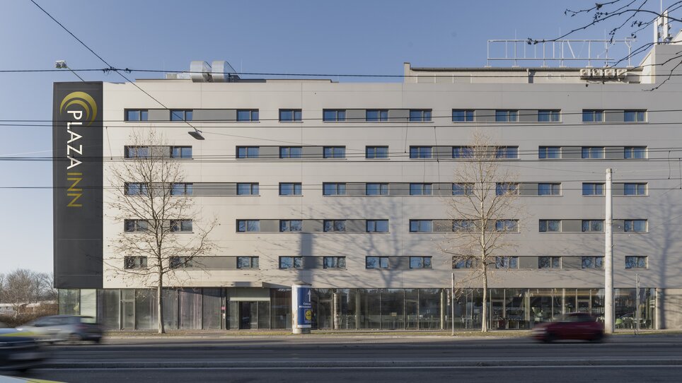 Hotel building with glass front and multiple windows. | © Plaza INN Graz
